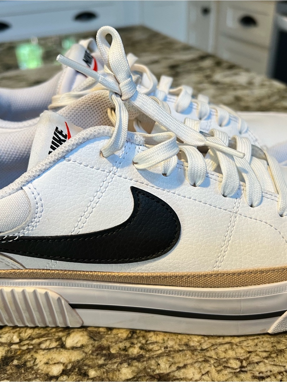 Nike White Low-Top Sneakers with Black Swoosh and Tan Accent